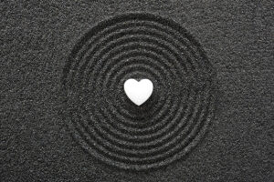 Heart in black sand