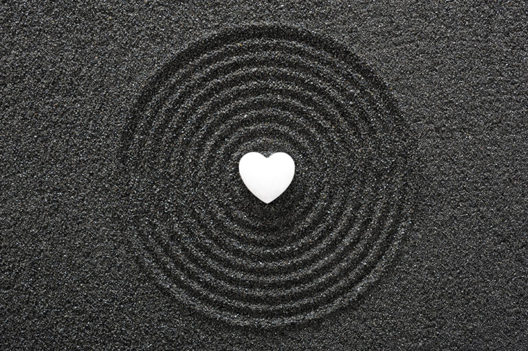 Heart in black sand