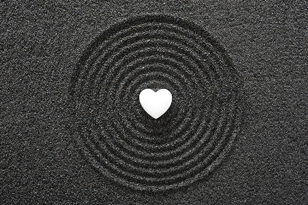Japanese zen garden with stone in textured sand. Representing the concept of spirituality.