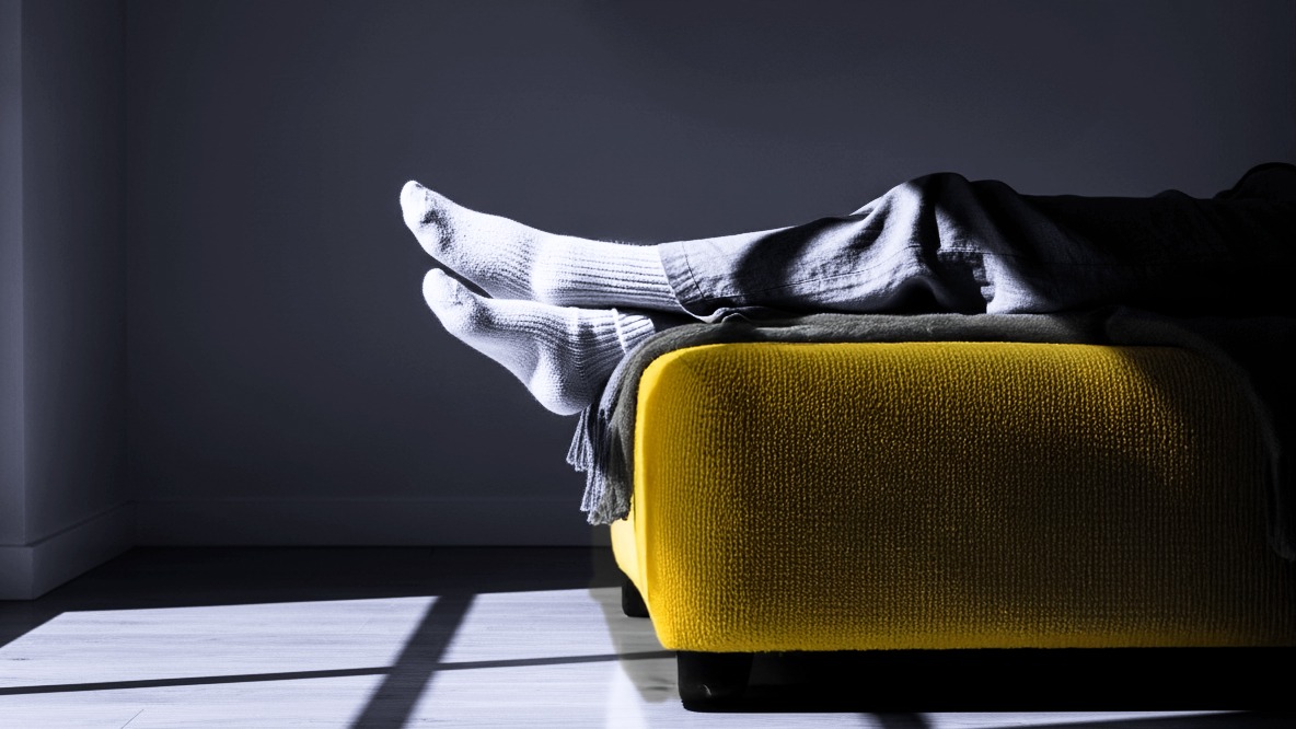 Feet resting on a yellow couch. Representing good mental health