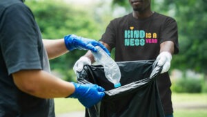 T-Shirt with "Kindness is a Verb" in bold bright fonts and colors. Showing personal style