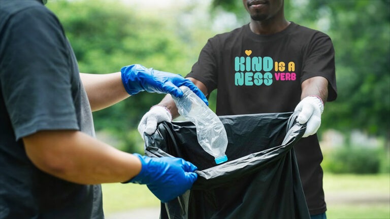 T-Shirt with "Kindness is a Verb" in bold bright fonts and colors. Showing personal style