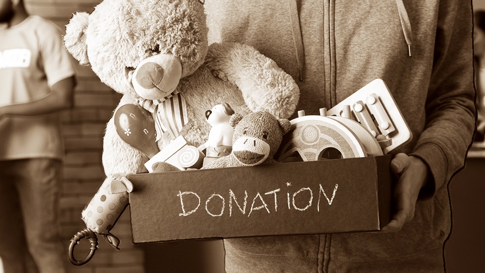 Benefits of Kindness - Person donating a box of toys.